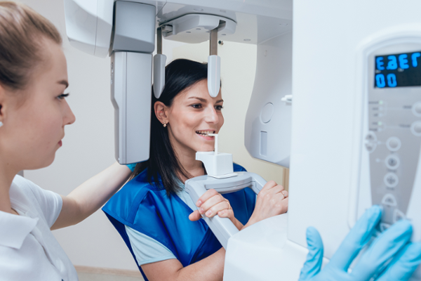 Technician helping patient take xrays